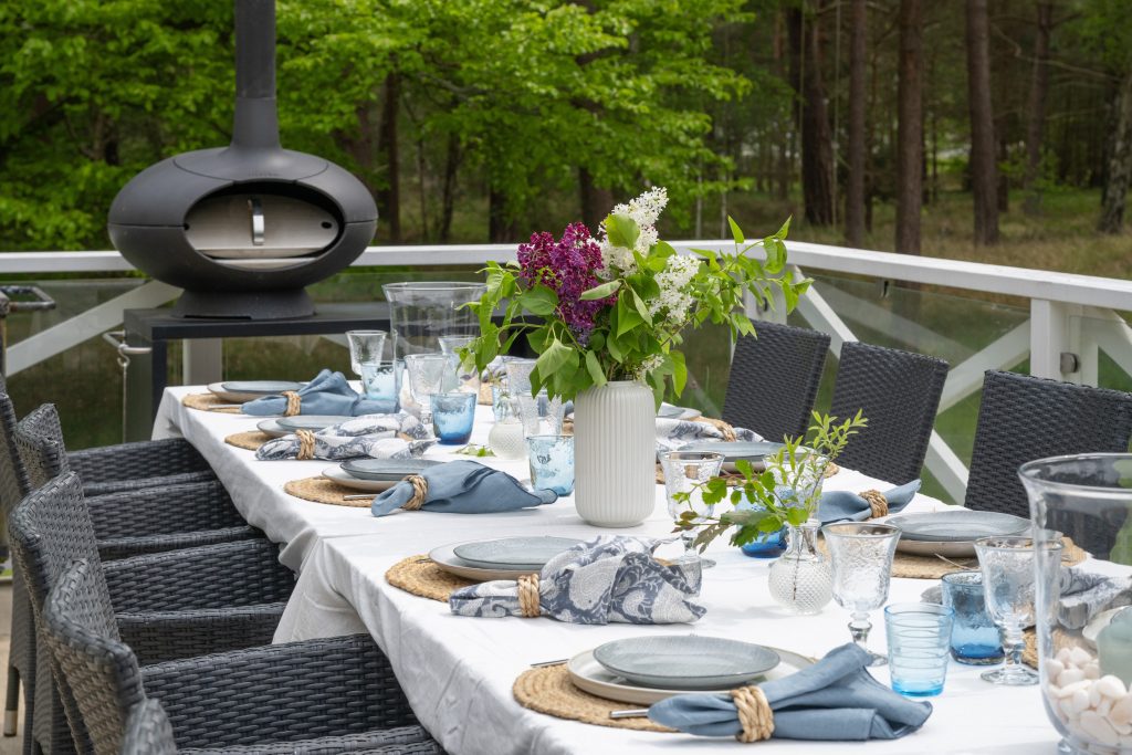 Outdoor dining table on the terrace at a modern villa in Höllviken, South Sweden surrounded by forest
