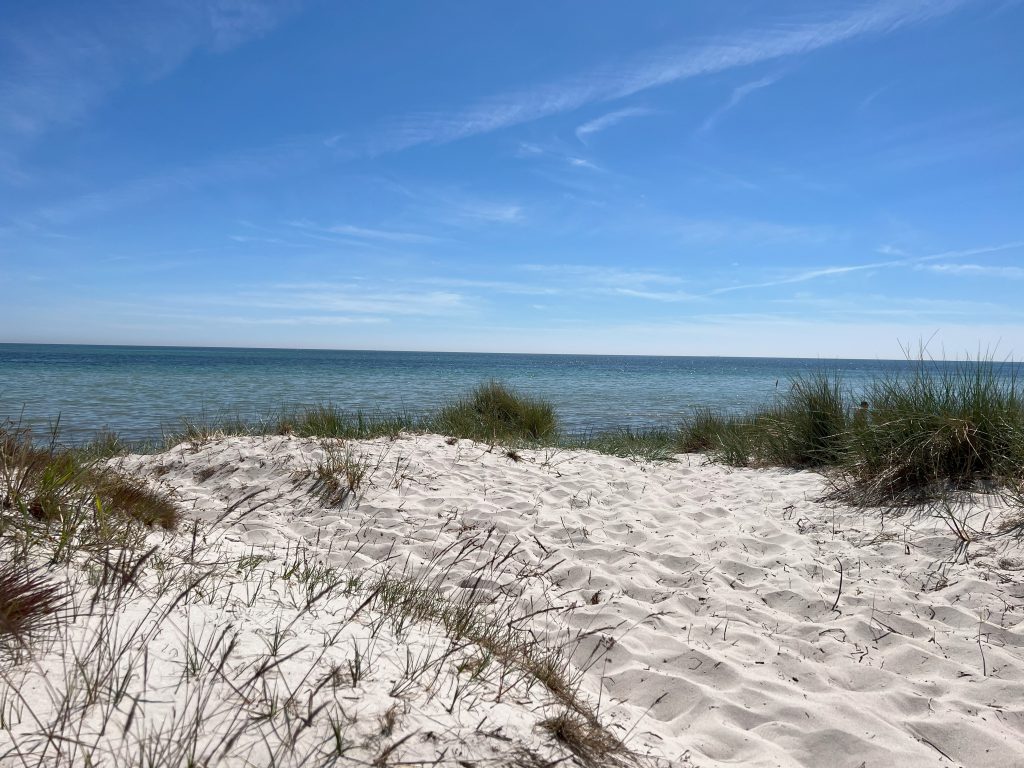 White sandy beach in Höllviken, South Sweden with shallow calm water near the villa