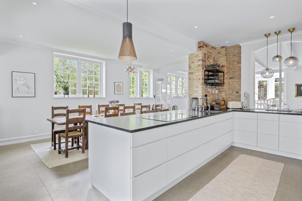 Modern kitchen and dining area in a spacious villa in Höllviken, South Sweden with open layout