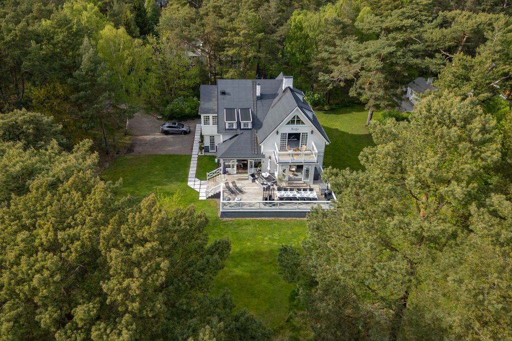 Aerial view of modern villa in Höllviken, South Sweden surrounded by forest and nature