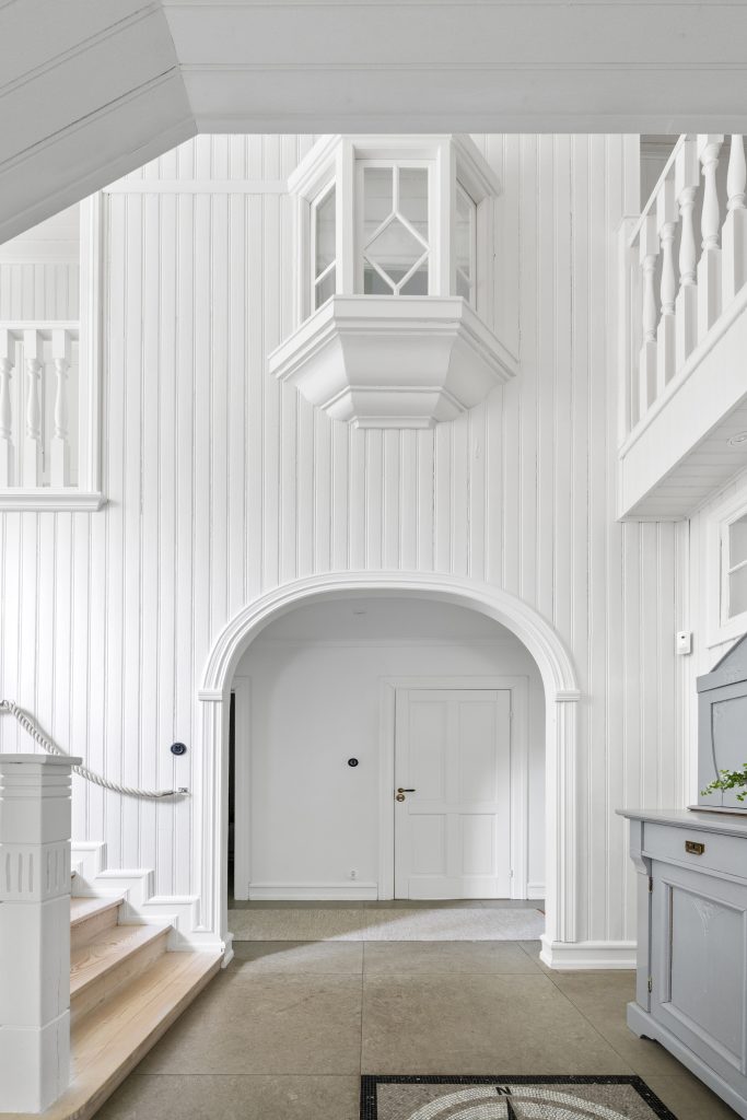 Spacious Scandinavian interior with high ceiling and staircase in a modern villa in Höllviken, South Sweden